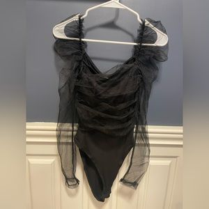 NWT black puffy sleeve body suit. Probably best for long torso